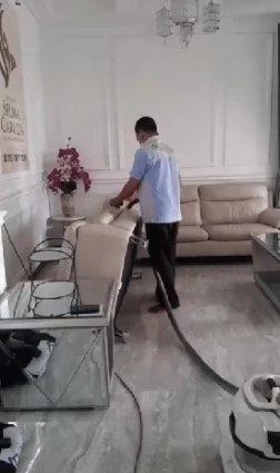 Vacuuming the lounge sofa