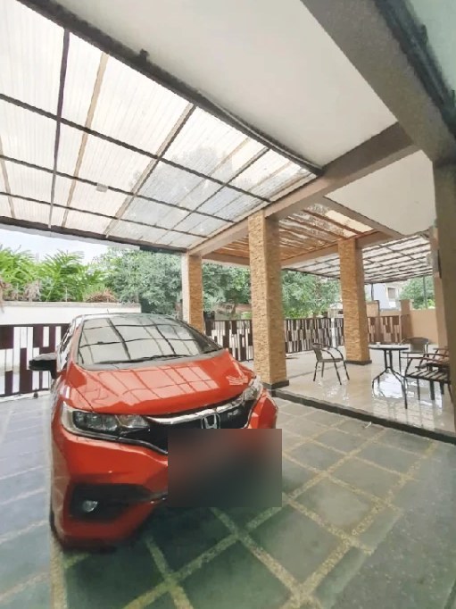 Covered garage with a car parked