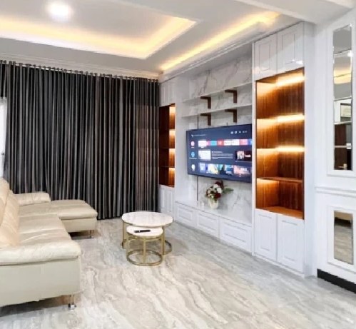 Family room with sofa and TV wall