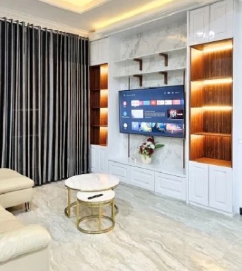 TV wall with warm-lit shelves