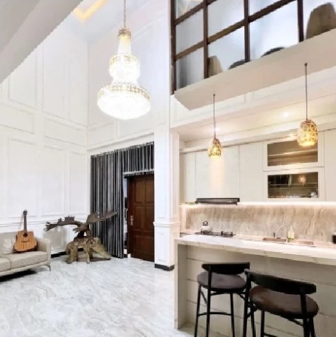 Kitchen with bar stools under a chandelier