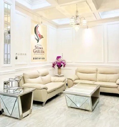 Front lounge with leather sofas and mirrored tables